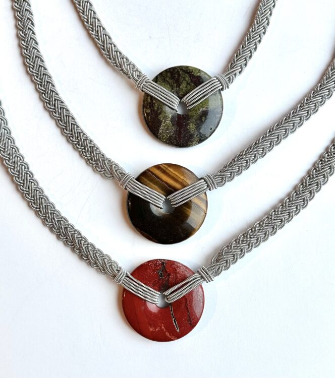 Thursday, June 8, 10 am - 1 pm
Katherine Buenger


Learn new skills in tin braiding while creating a necklace featuring a stone donut-shaped pendant. Using tin thread and a fine wire wrapped around a fiber core (4% silver), weave a 5 strand braid onto a stone donut to create a necklace with a silver plated clasp. Experience how the ancient art of tin braiding opens up a world of creative possibilities. Beginners welcome!

Materials fee is $40, payable to instructor at the time of class, and includes all necessary supplies to make one necklace. 





Instructor Bio:
Katherine Buenger (she/her) has a degree in studio art from Macalester College. She enjoys many fiber-related arts, including weaving, spinning, ply-split braiding, button making, and braiding with Sami tin thread. Whether it is spinning the yellow pages, computer tape, or adding telephone wire to weavings, she likes finding something different and fun to do with her art. She is not afraid to break the rules and try something new, and encourages others to do the same. Katherine has taught at The Weavers Guild of Minnesota, Midwest Weavers Conference, Minnesota Federation of Weavers and Spinners, White Bear Center for the Arts, Marine Mills Folk School, American Kumihimo Society, Upper Midwest Bead Society and other venues. After teaching thousands of students, she is still having fun sharing her crafts with others.



NOTE: Under SHIPPING in your shopping cart, PLEASE CHECK “CLASS/EVENT: NO SHIPPING REQUIRED